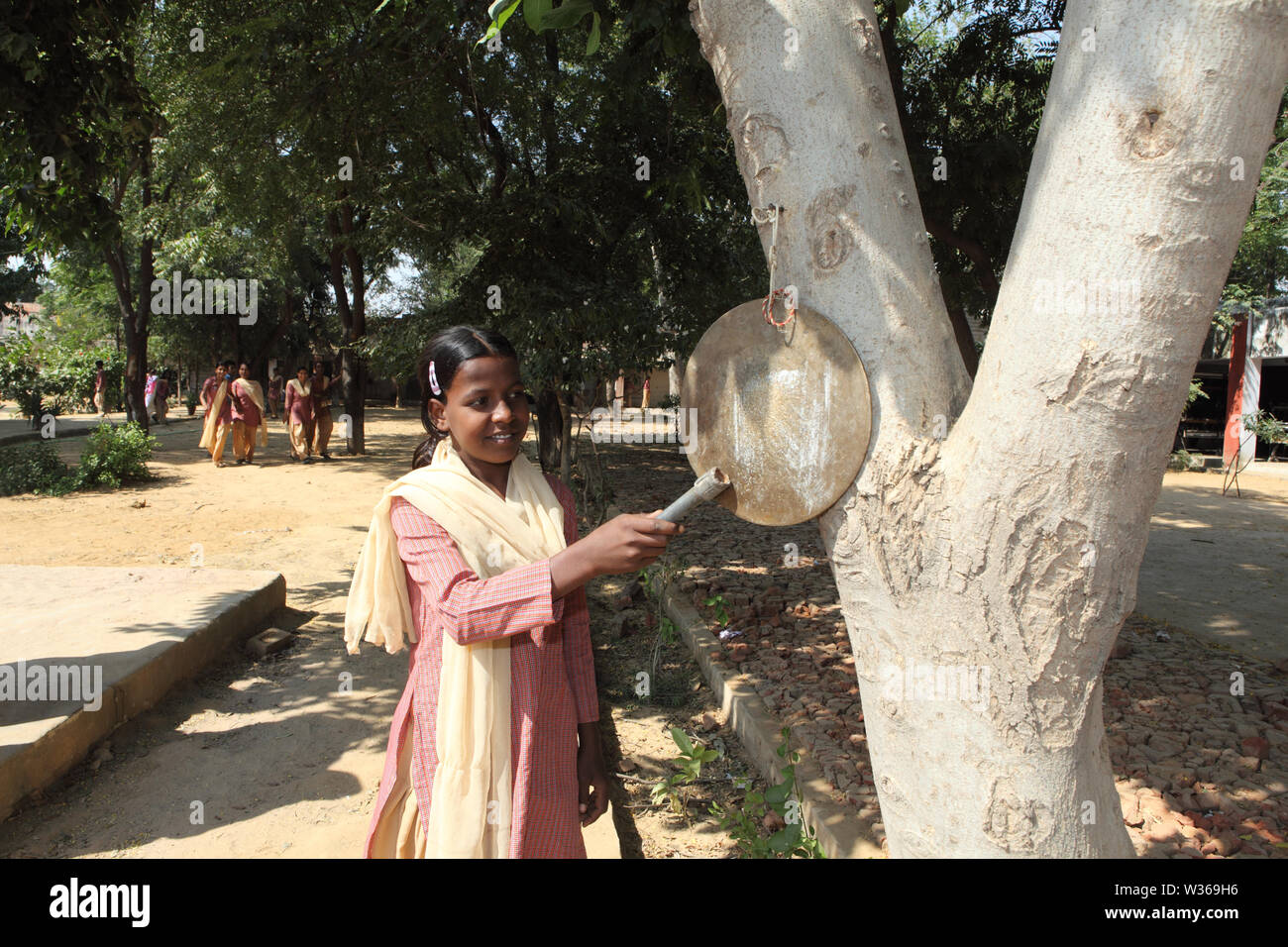 Bell Ringing Girls Schoolgirl ringing bell in school Stock Photo - Alamy
