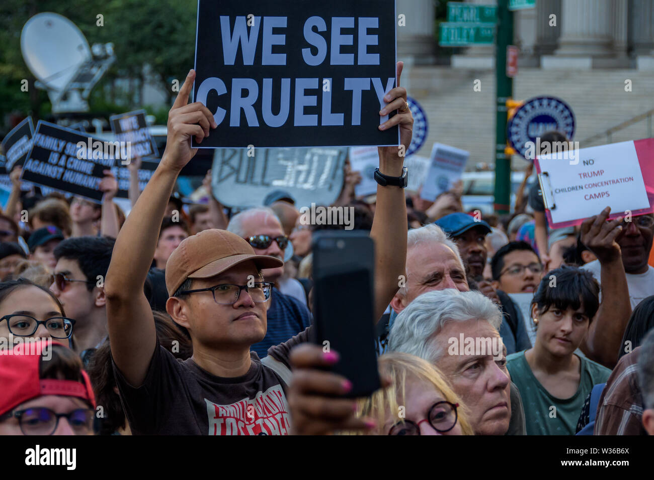 New York, USA. 12th July, 2019. Thousands of advocates, activists and community members flooded the streets at Foley Square, across from the Immigration and Customs Enforcement (ICE) New York Field Office on July 12, 2019 to join New Sanctuary Coalition and The New York Immigration Coalition at the Lights for Liberty vigil, deemed one of the largest solidarity actions in history with over 750 vigils across 5 continents. A light was lit for all those held in U.S. detention camps and to bring light to the darkness of the Trump administration's horrific policies. Credit: PACIFIC PRESS/Alamy Live  Stock Photo
