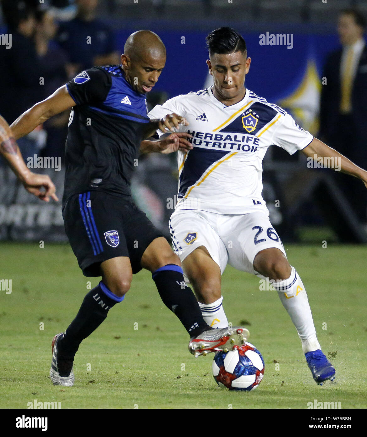 Los Angeles, California, USA. 12th July, 2019. LA Galaxy midfielder Efrain Alvarez (26) and San Jose Earthquakes forward Chris Wondolowski (8) vie for the ball during the 2019 Major League Soccer (MLS) match between LA Galaxy and San Jose Earthquakes in Carson, California, July 12, 2019. The Earthquakes won 3-1. Credit: Ringo Chiu/ZUMA Wire/Alamy Live News Stock Photo