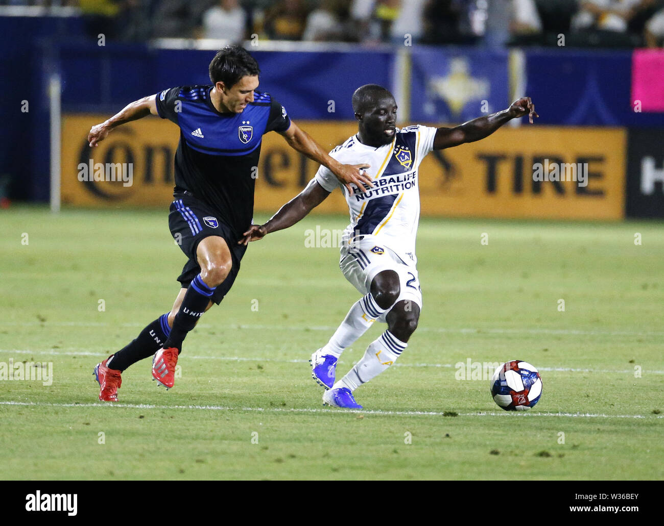 Los Angeles, California, USA. 12th July, 2019. LA Galaxy midfielder Emmanuel Boateng (24) and San Jose Earthquakes forward Chris Wondolowski (8) vie for the ball during the 2019 Major League Soccer (MLS) match between LA Galaxy and San Jose Earthquakes in Carson, California, July 12, 2019. The Earthquakes won 3-1. Credit: Ringo Chiu/ZUMA Wire/Alamy Live News Stock Photo