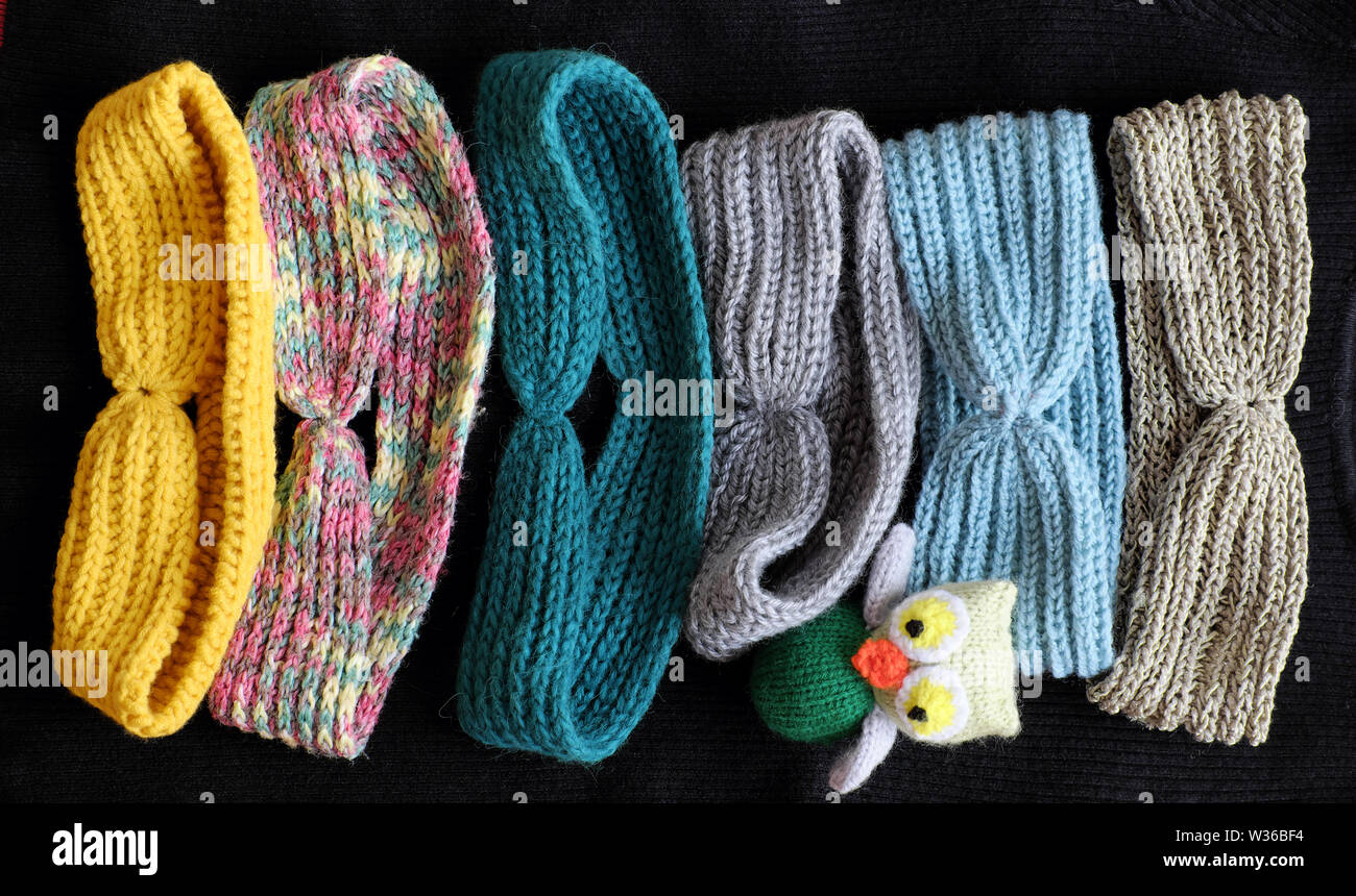 Group of handmade head bands knit in free time as leisure activity at home, accessories for woman from yarn Stock Photo