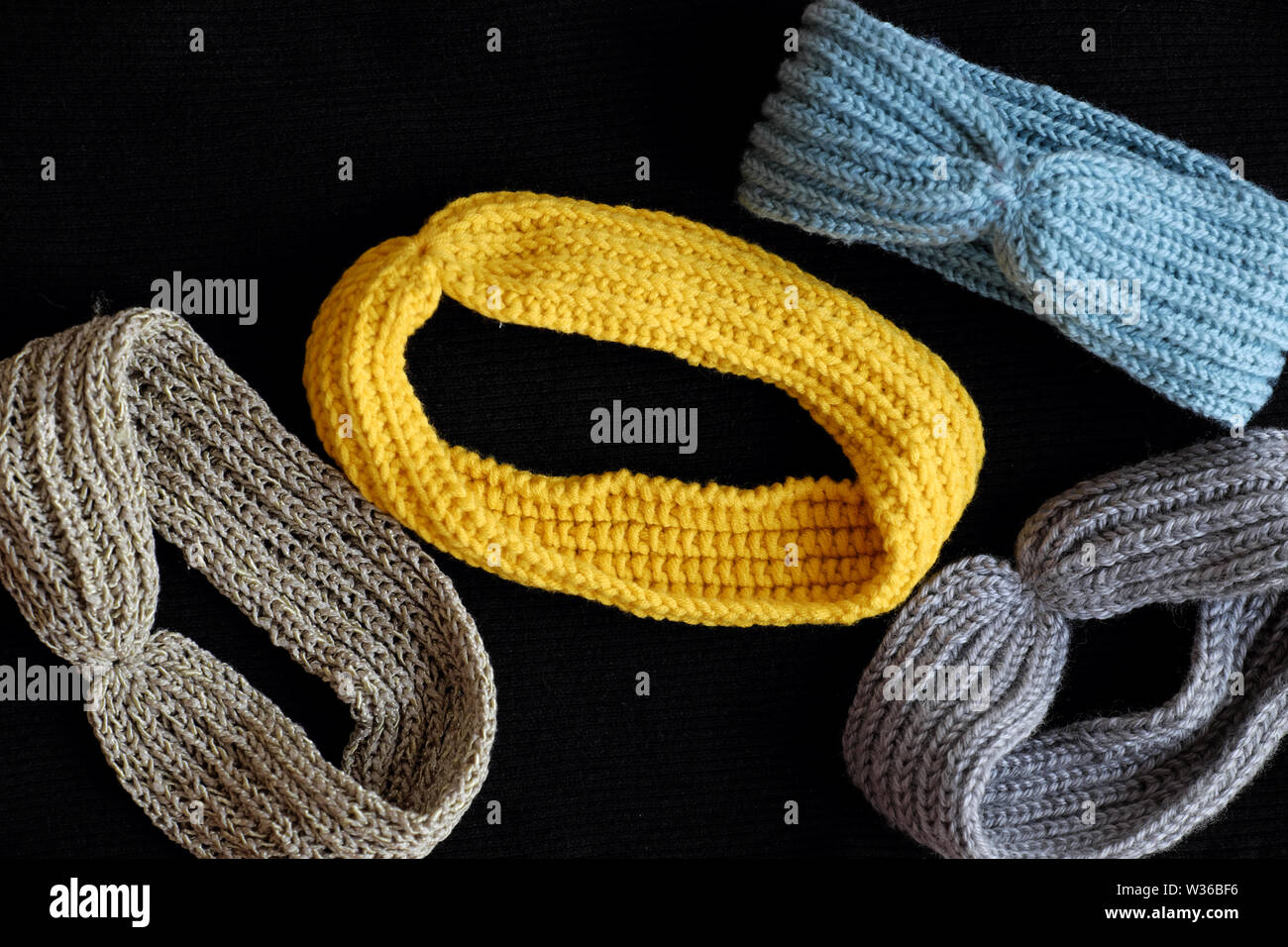 Group of handmade head bands knit in free time as leisure activity at home, accessories for woman from yarn Stock Photo
