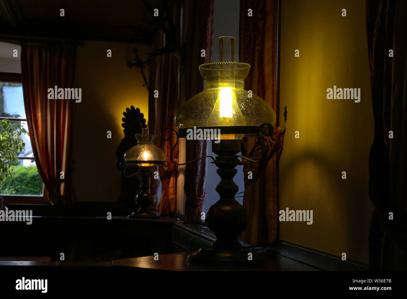 A beautiful table lamp stands in a room Stock Photo Alamy