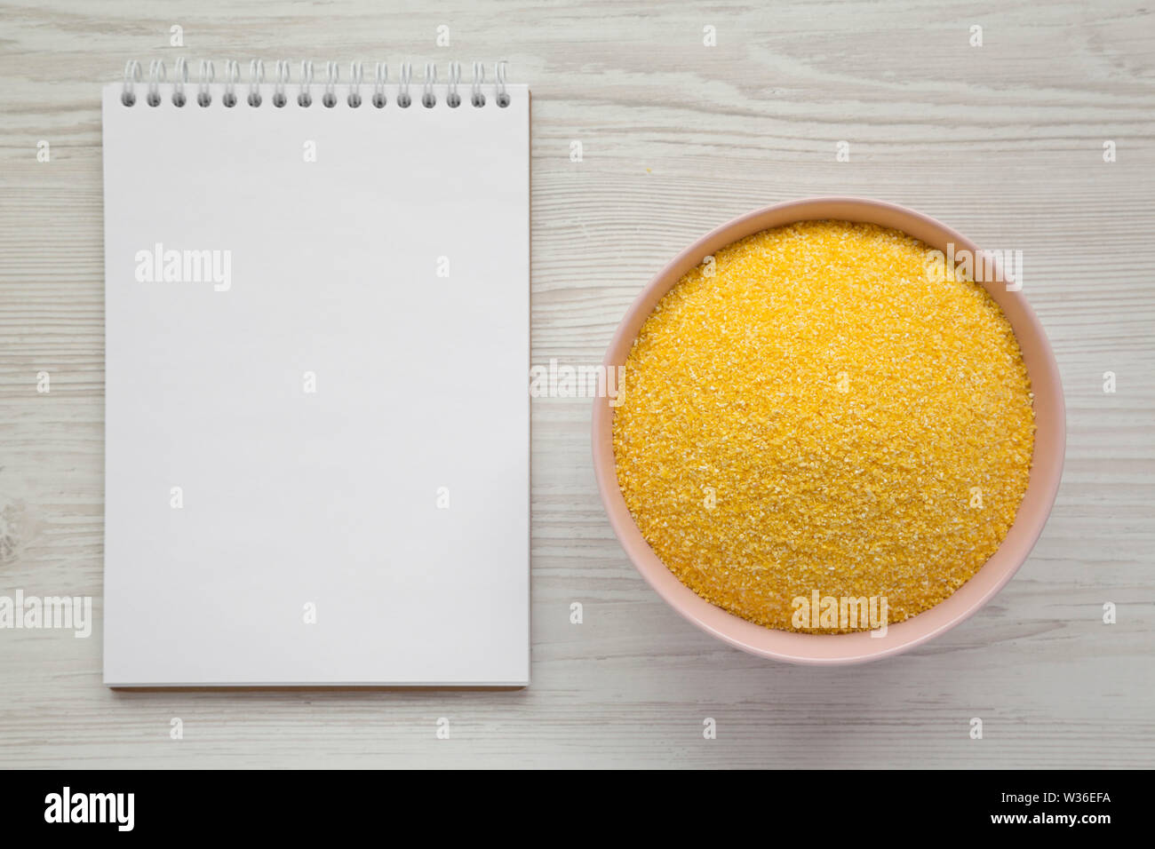 Corn Notepad Organic Masarepa corn meal in a pink bowl, blank notepad over white ...
