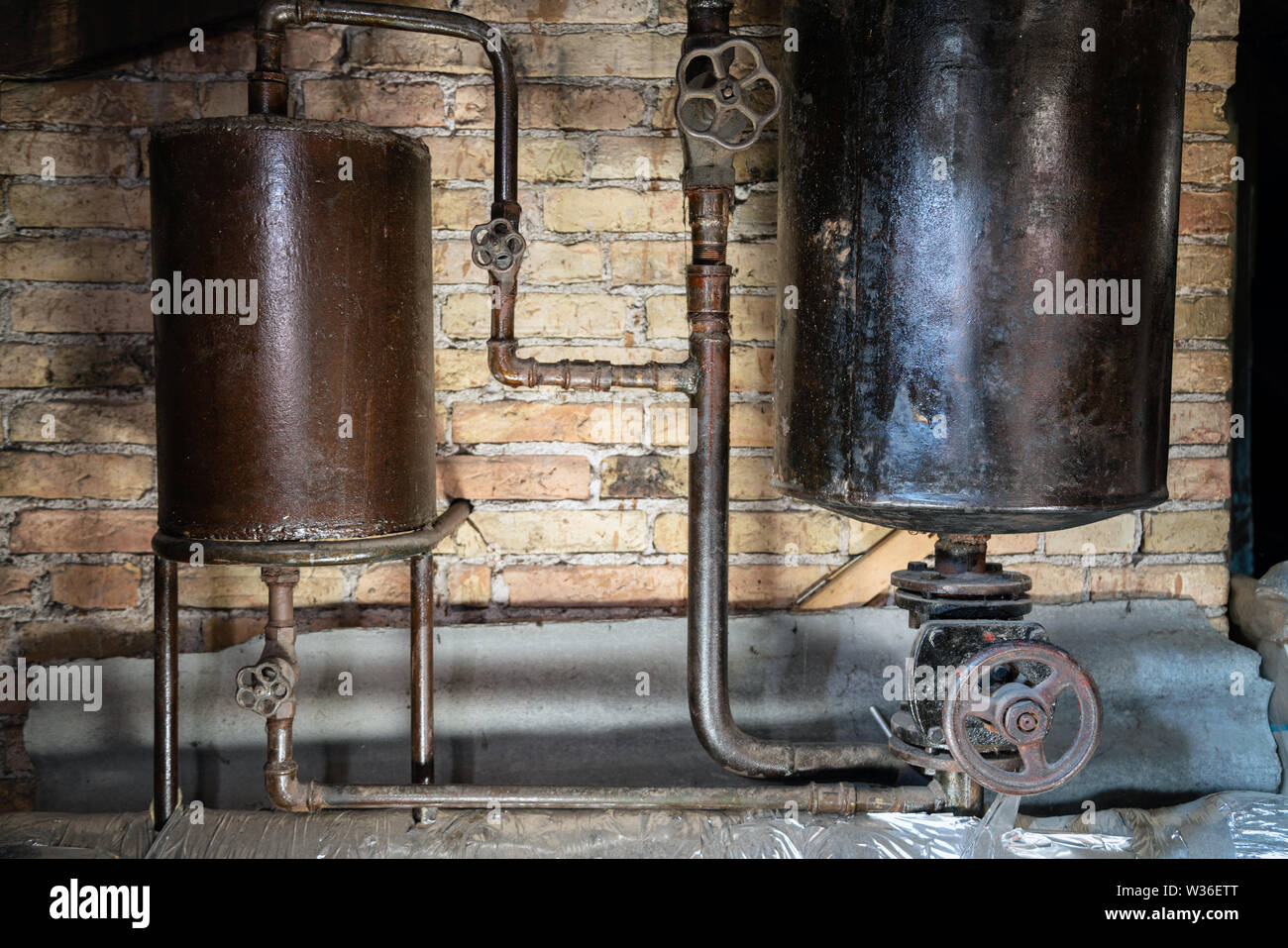 Rusty boiler room pipes. Old metal boiler generating heating and