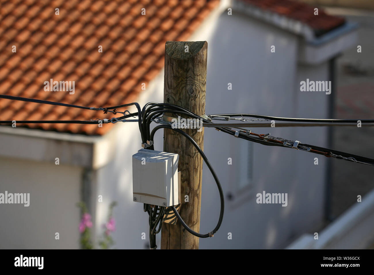 Distribution box on a high wooden power pole. Stock Photo