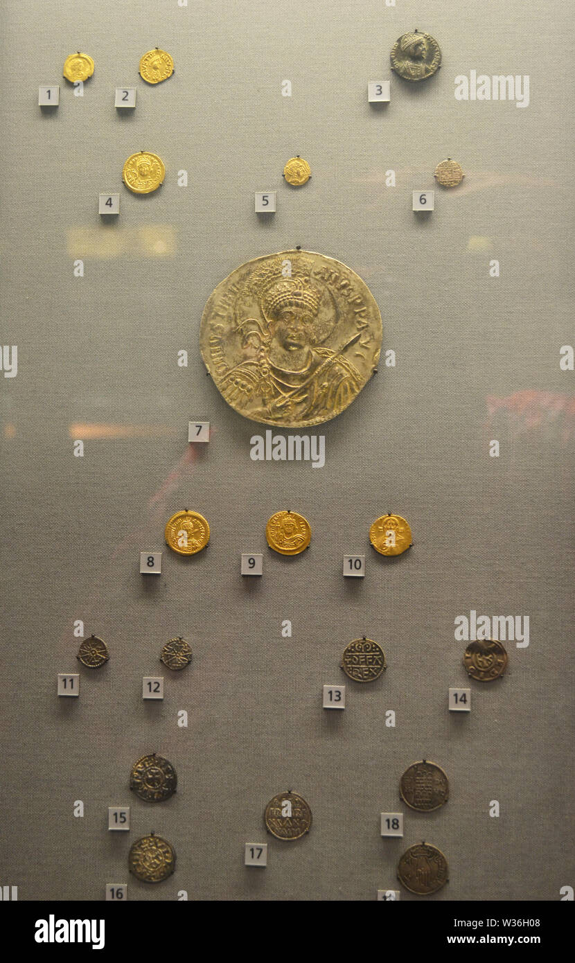 Ancient Roman coins including the electrotype gold medallion of Justinian I (527-565) in Manchester Museum, UK. Part of the University of Manchester. Stock Photo