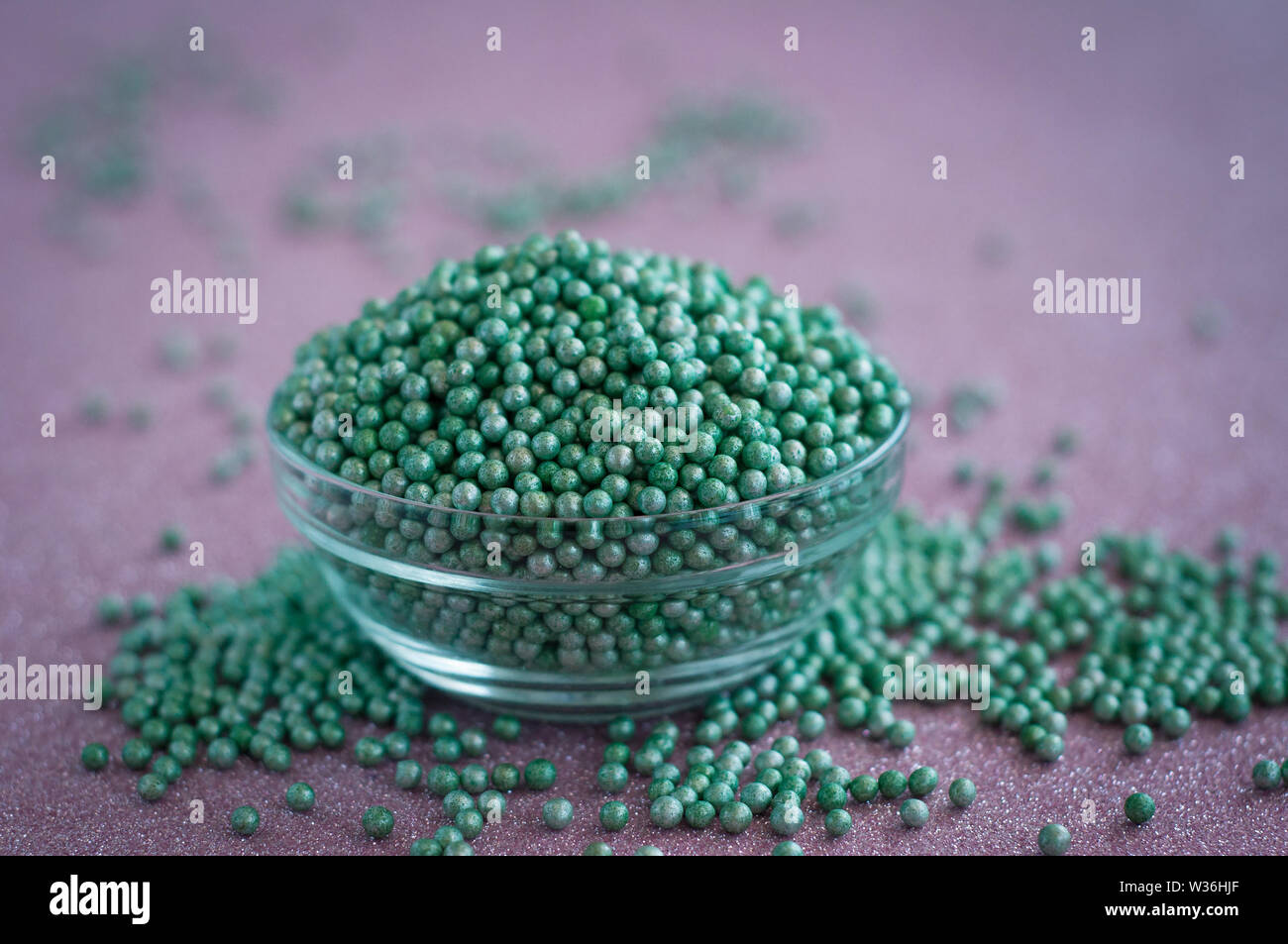 Green ball crystal sugar sprinkle dots, on glitter pink background