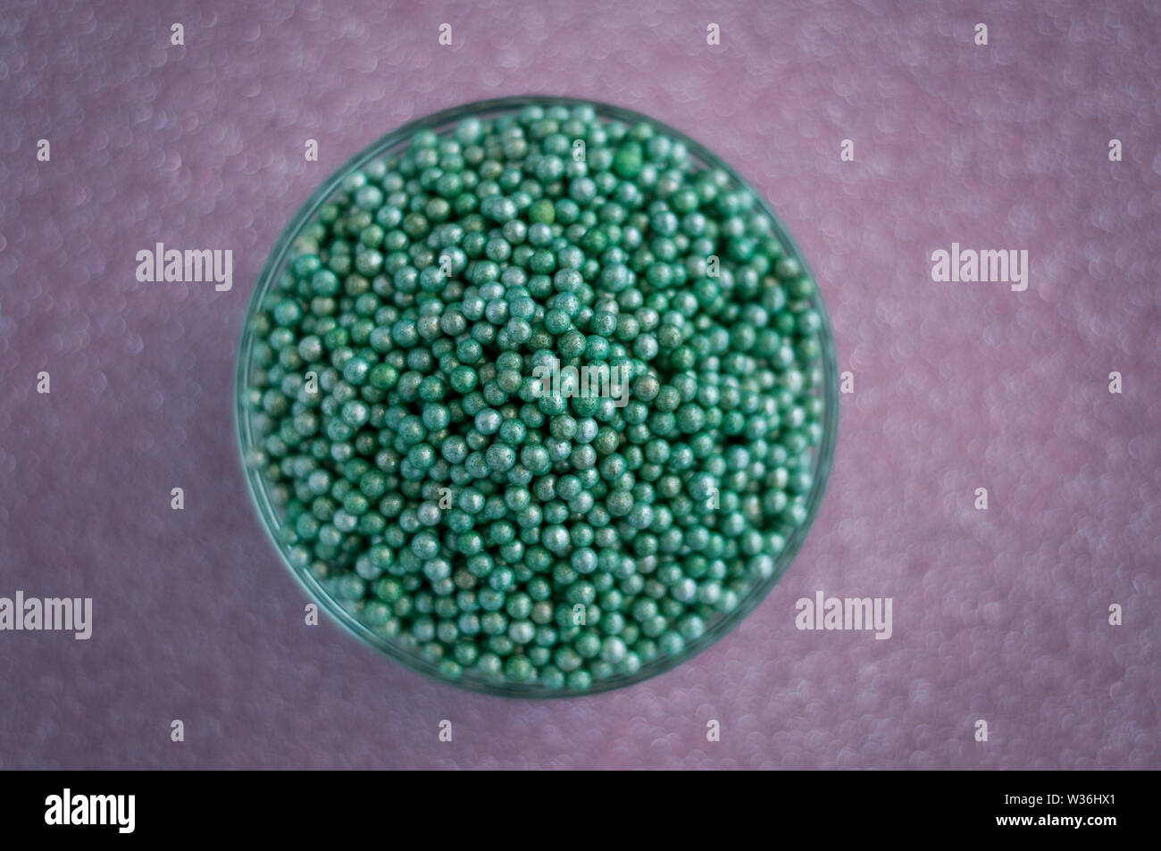 Green ball crystal sugar sprinkle dots, on glitter pink background