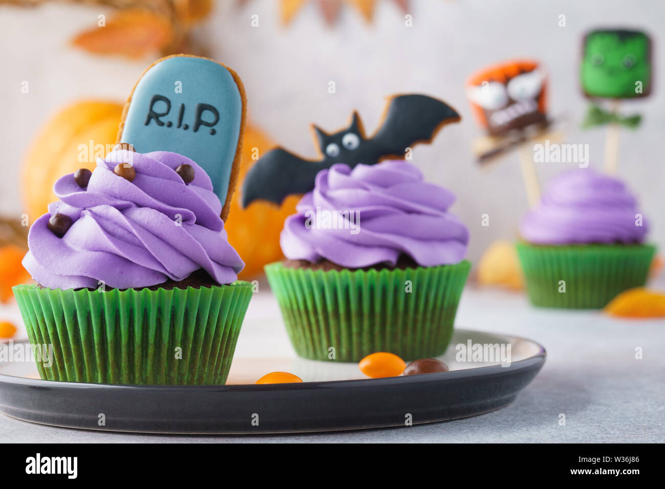 Set Of Halloween Cupcakes Decorated With Gingerbread Cookies And