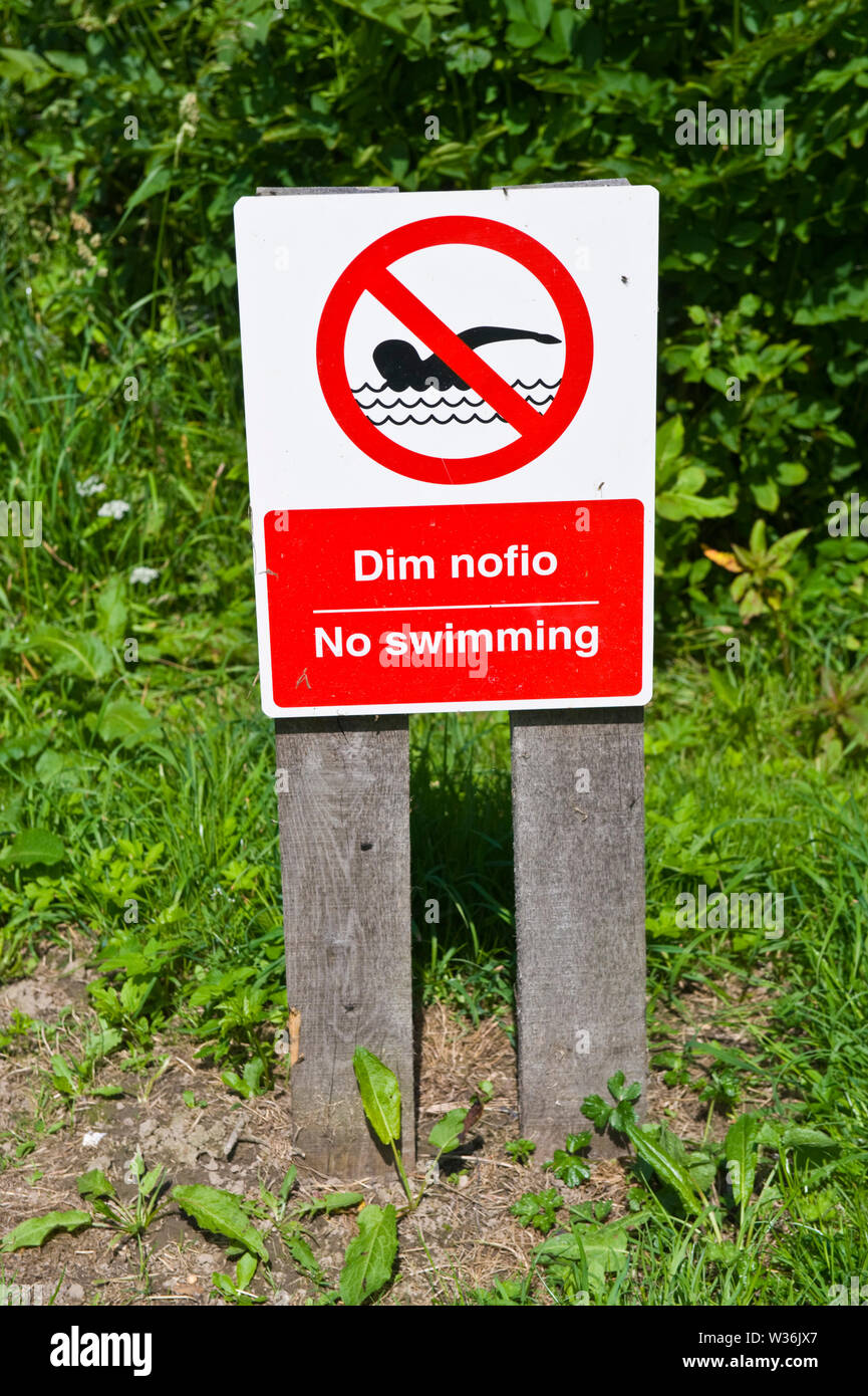 No Swimming sign on the riverbank of the River Wye at Builth Wells Powys Wales UK Stock Photo