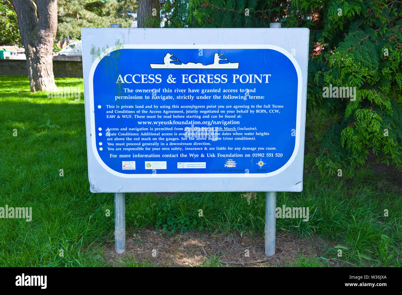 Canoe access and egress point sign on the riverbank of the River Wye at Builth Wells Powys Wales UK Stock Photo
