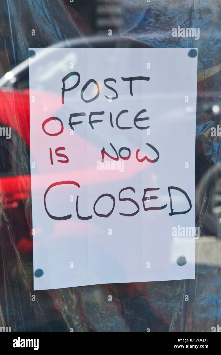 Post Office closed sign on shop window in the town centre at Builth Wells Powys Wales UK Stock Photo