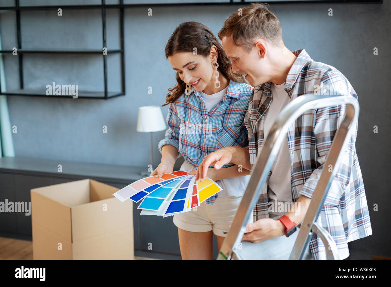 Couple choosing color for furniture in new house Stock Photo Alamy