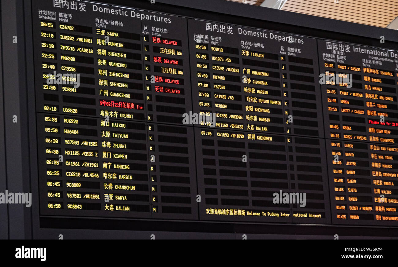 Close-up shot of airport timetable arrivals and departures board with changing flight information Stock Photo