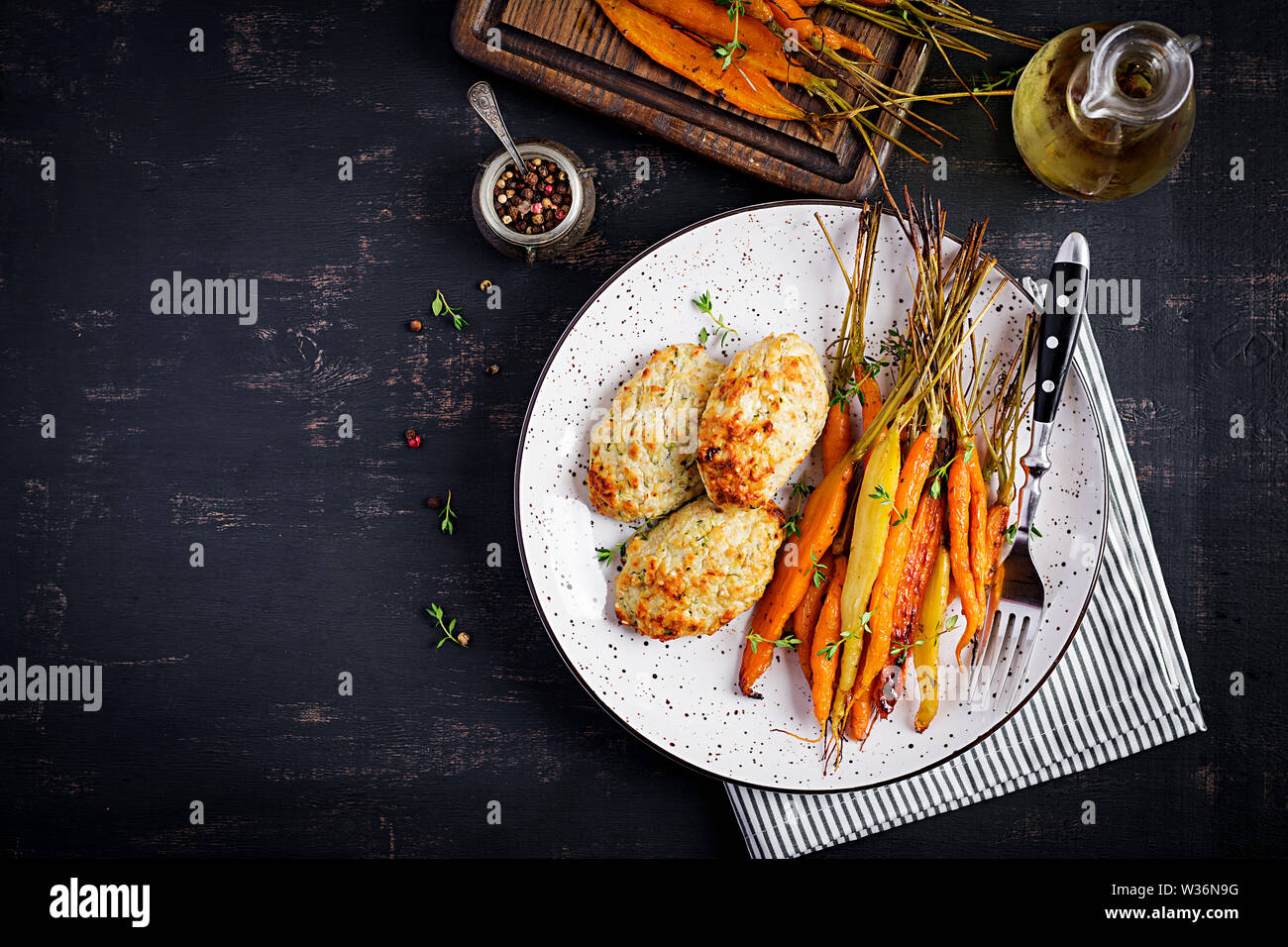 Baked organic carrots with thyme and cutlet/meatball chicken meat and