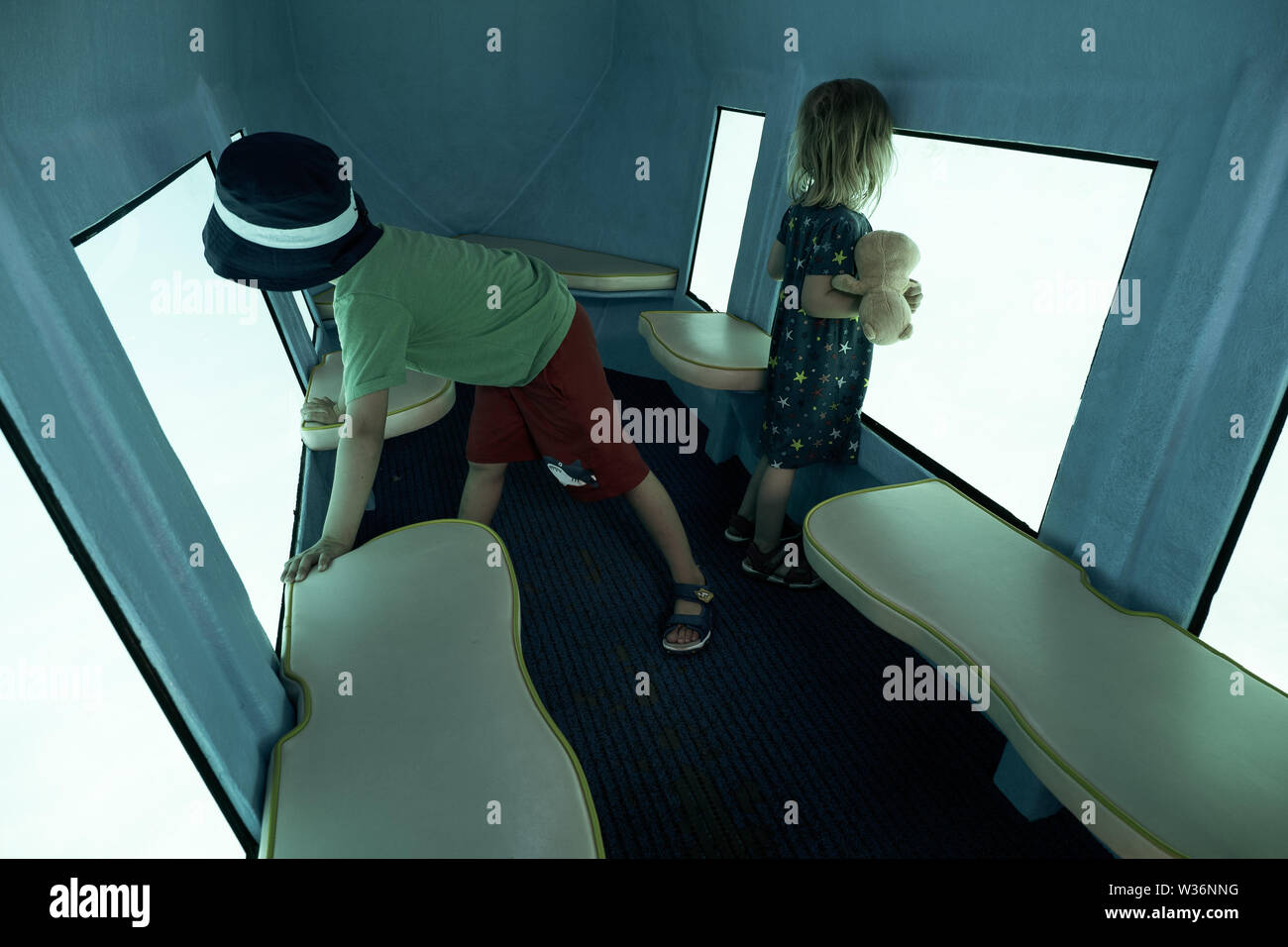 3 and 5 years old kids looking through the window of a glass bottom boat navigating through the Adriatic sea off the coast of Krk Island, Croatia Stock Photo