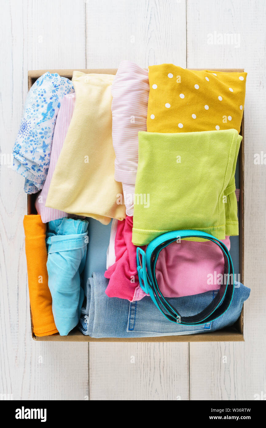 https://c8.alamy.com/comp/W36RTW/various-colorful-clothes-in-a-box-for-shipping-or-donation-clothing-for-children-and-teenagers-overhead-shot-W36RTW.jpg
