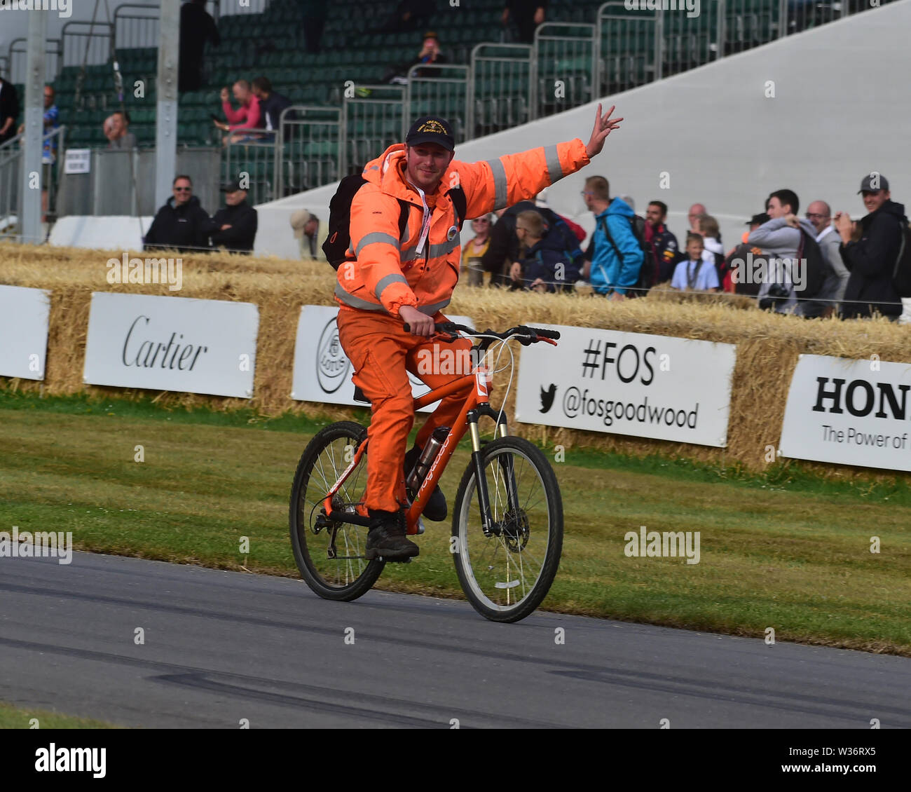 That's all folks, Time to go home, marshal on a bicycle, Goodwood Festival of Speed, 2019, Festival of Speed, Speed Kings, Motorsport's Record Breaker Stock Photo