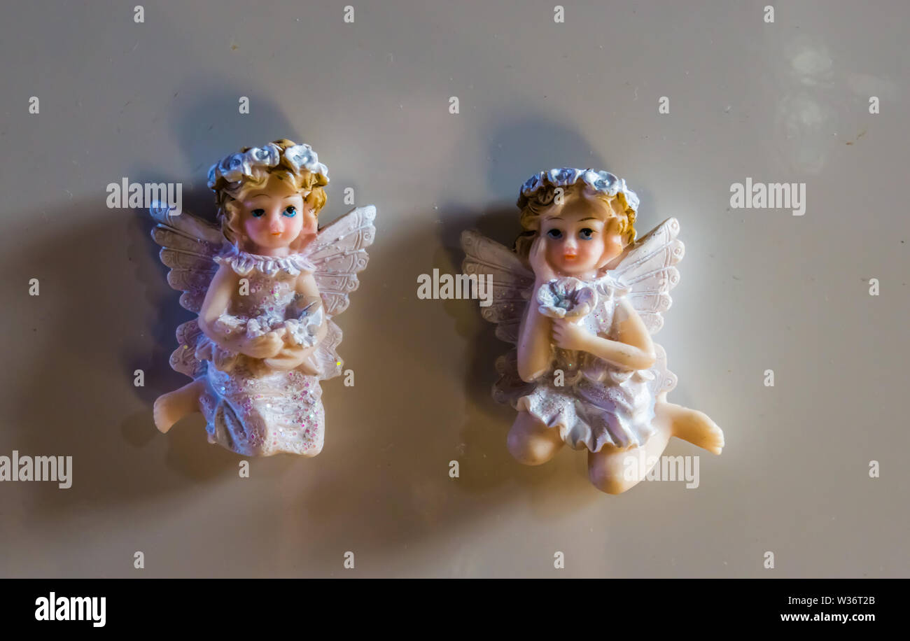 two beautiful angel magnet figurines on a white refrigerator Stock Photo -  Alamy
