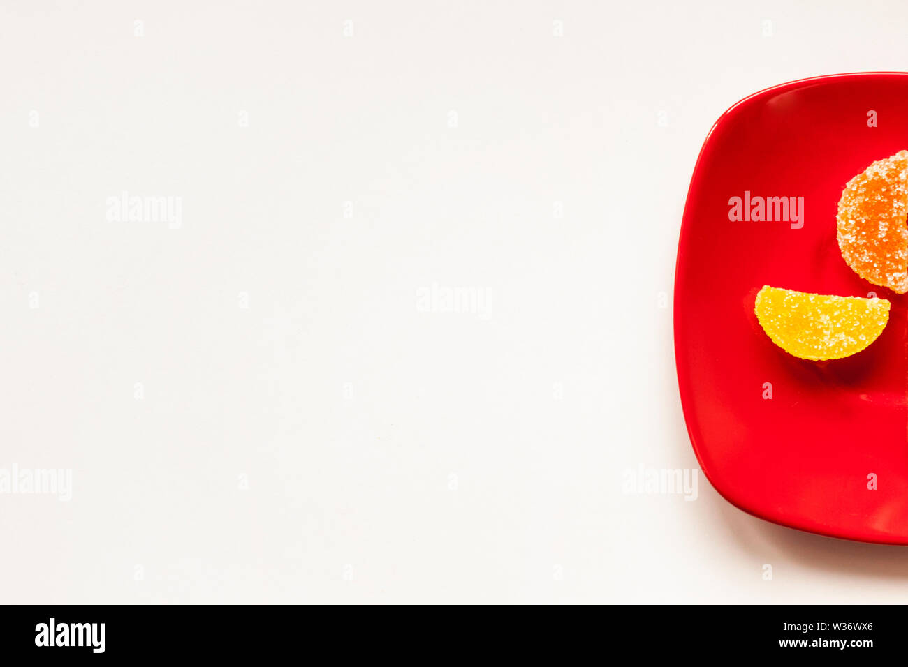 Two Sugar candies on a red plate Stock Photo