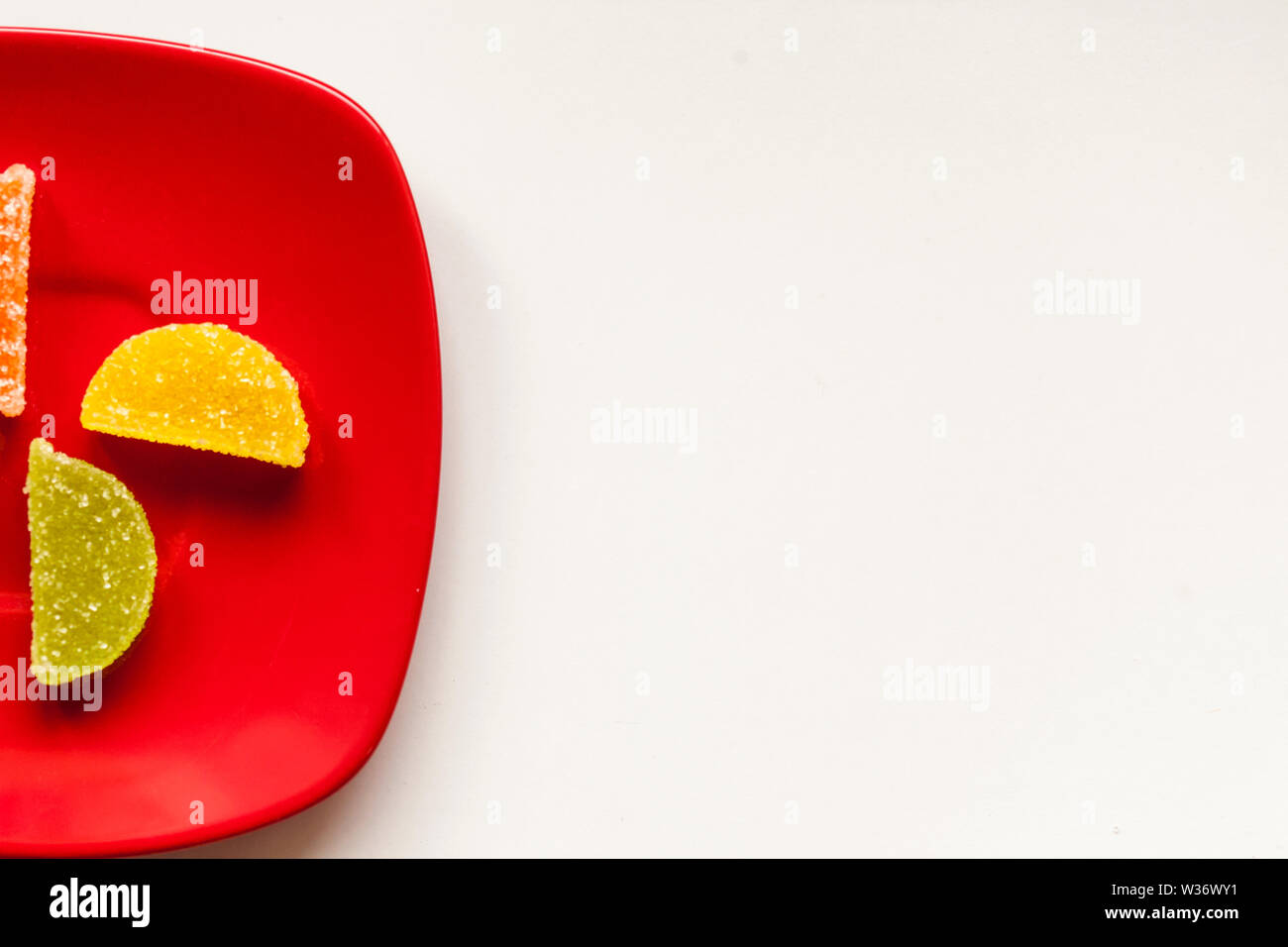 Two Sugar candies on a red plate Stock Photo