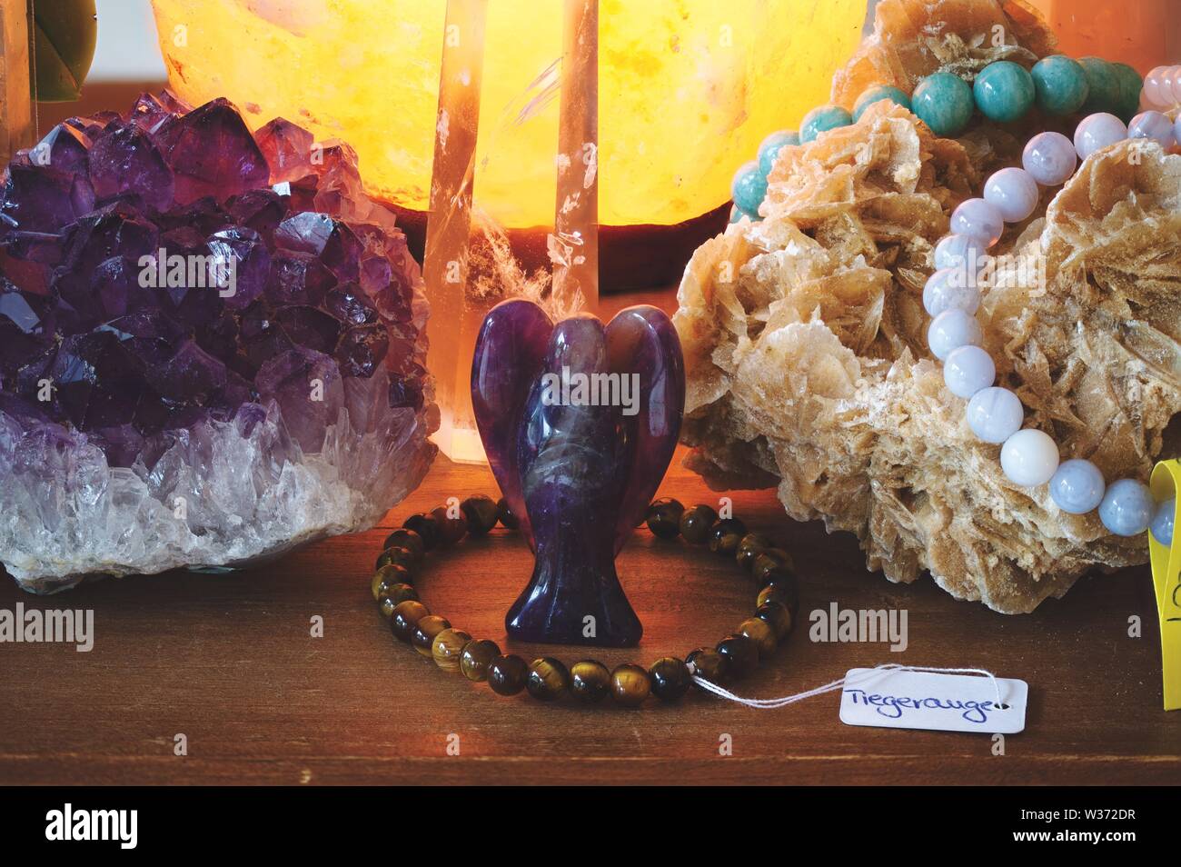 Amethyst Angel with other minerals on a table Stock Photo