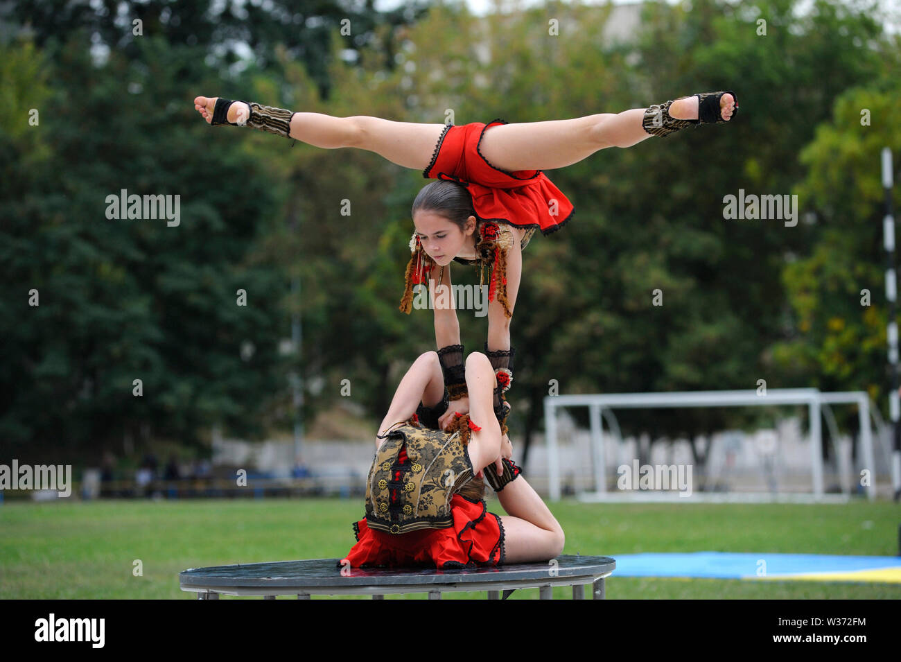 Group of little artistic gymnastics girls doing acrobatic exercises. June 20, 2019.Kiev, Ukraine Stock Photo