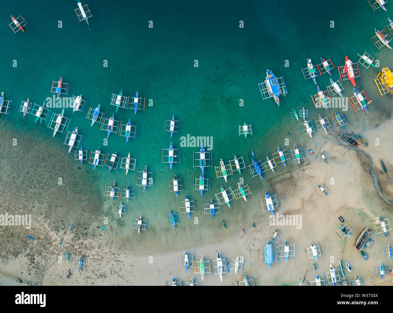 Aerial drone view of boats anchored in the bay with clear and turquoise water. Boats and yachts in the tropical lagoon. Tropical landscape. Stock Photo