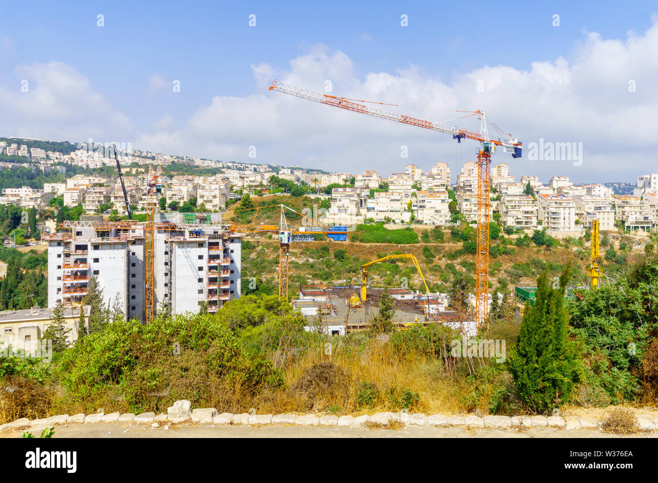 Haifa, Israel - July 12, 2019: Construction site of apartment buildings, with workers. Its an urban renewal project. Haifa, Israel Stock Photo