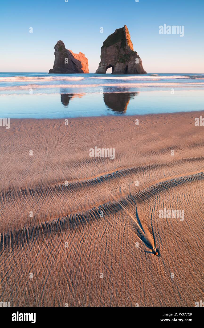 Rocky Islands, sand dunes, Wharariki Beach, Golden Bay, Nelson District, Southland, New Zealand Romantic landscape background  Sea stacks on Wharariki Stock Photo