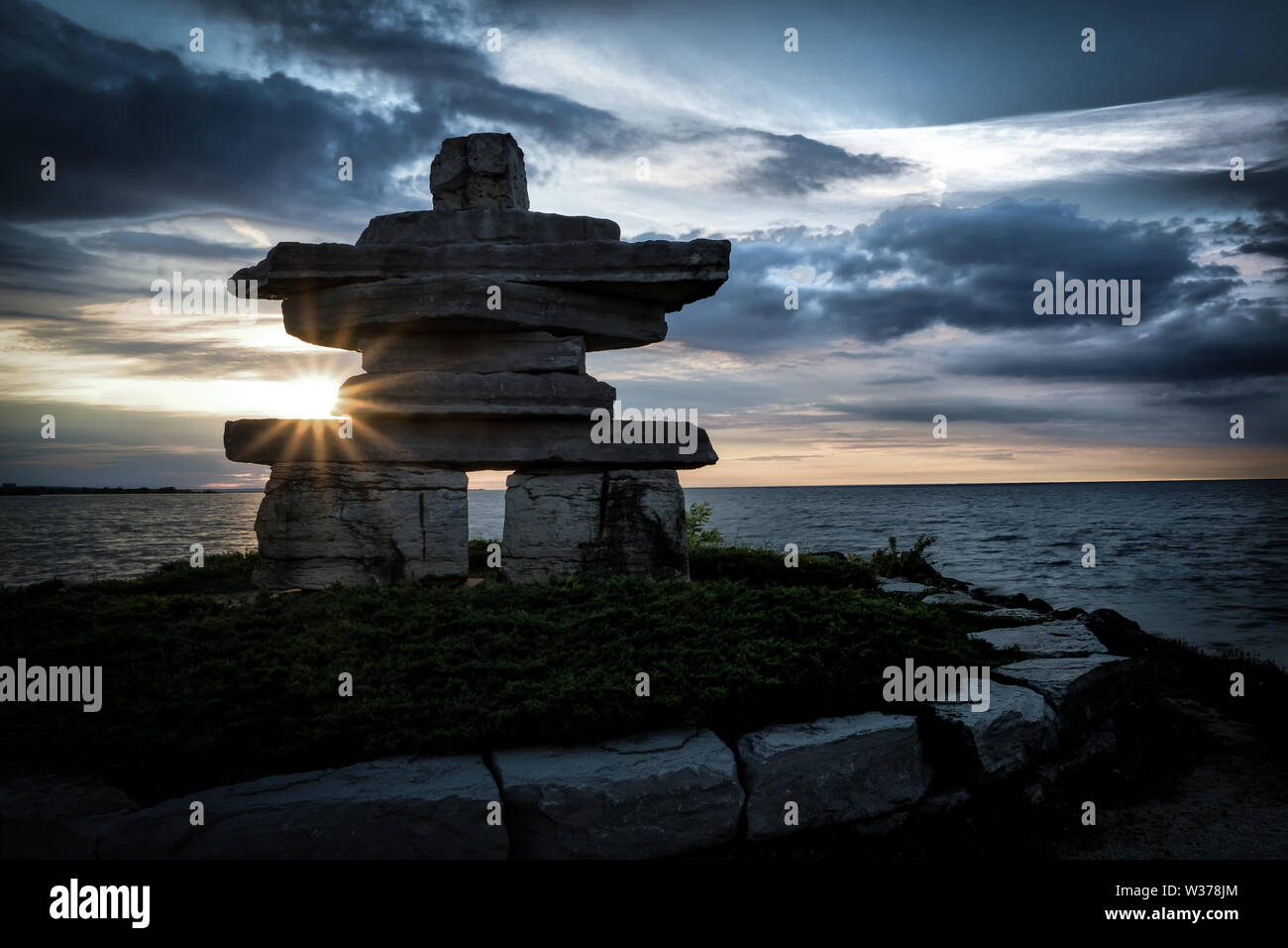 Canada Ontario Collingwood, Inukshuk at Sunset Point at sunset, June 2019, Inushuk Stone Landmark, we were here, Stock Photo