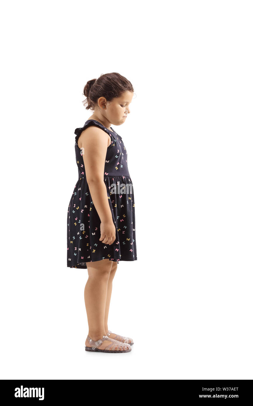 Full length profile shot of a sad little girl looking down isolated on white background Stock Photo