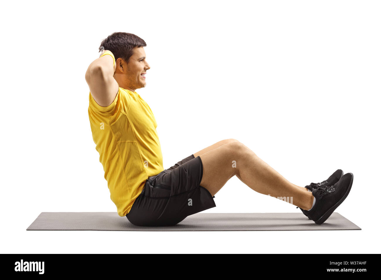 Young Man Exercising Abs On The Floor Isolated On White Background