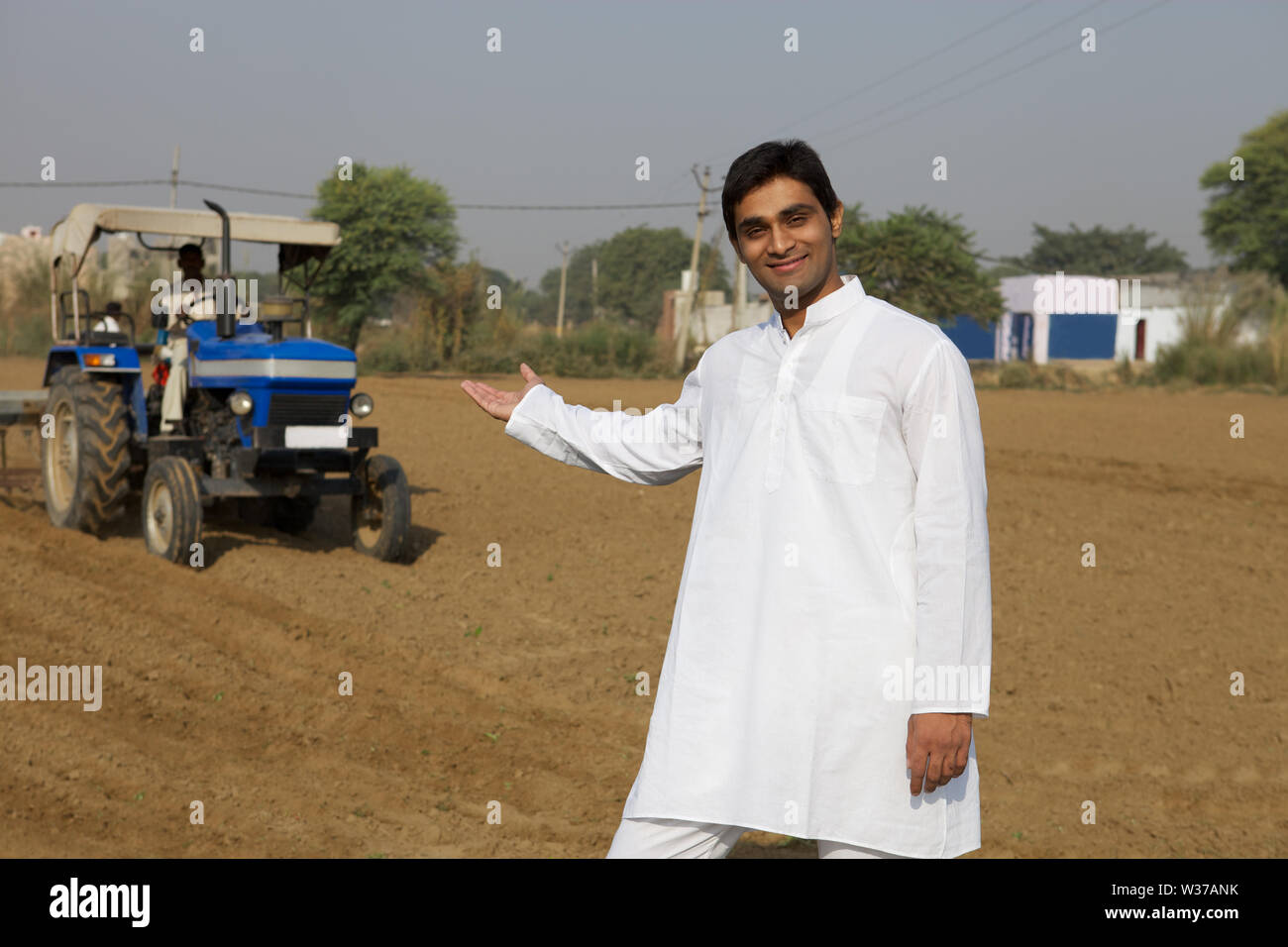 Portrait of a farmer showing his field Stock Photo - Alamy