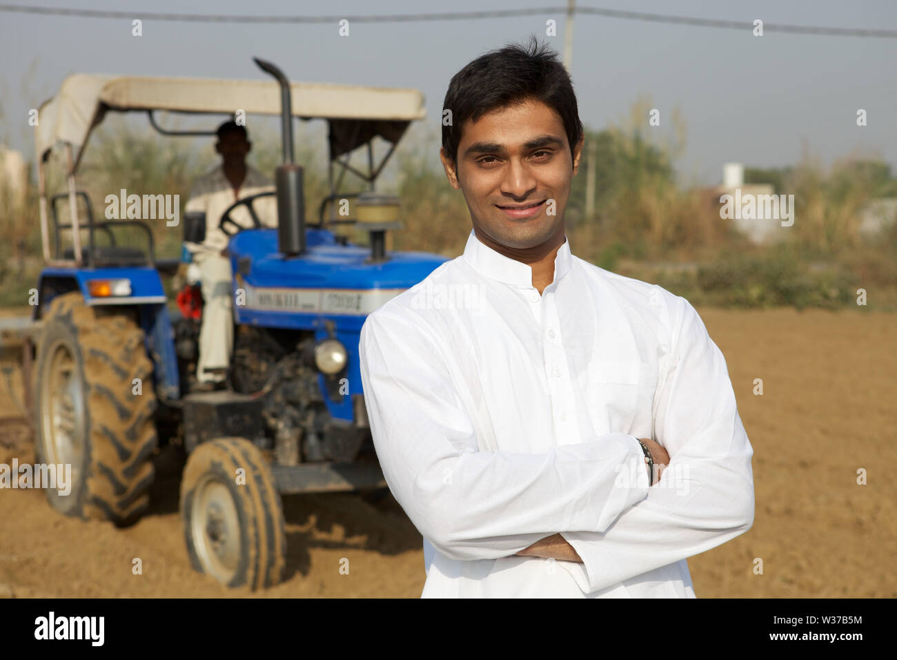 Portrait of a farmer standing with his arms crossed Stock Photo - Alamy