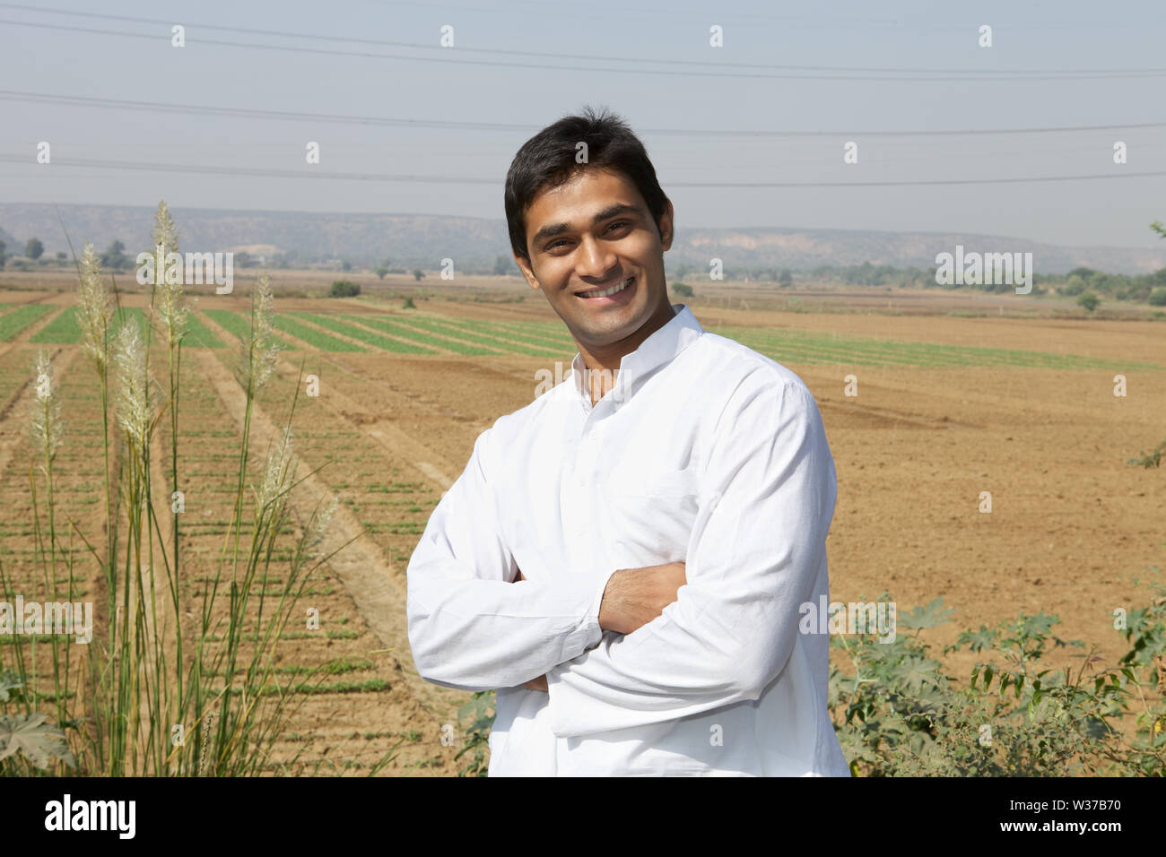 Portrait of a farmer smiling in a field Stock Photo - Alamy