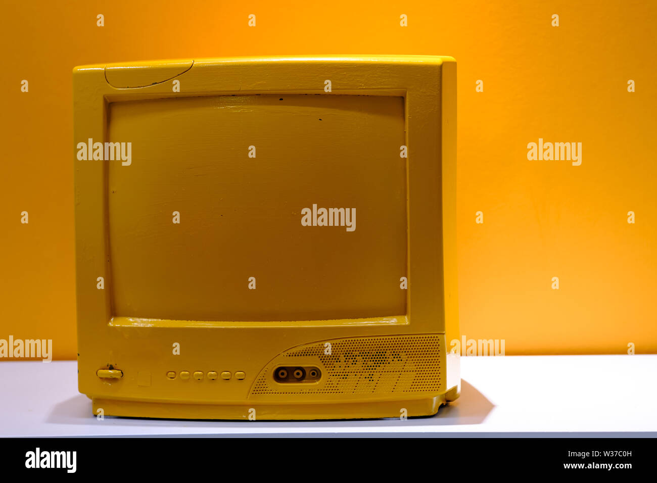 Retro old yellow TV display on table Stock Photo Alamy