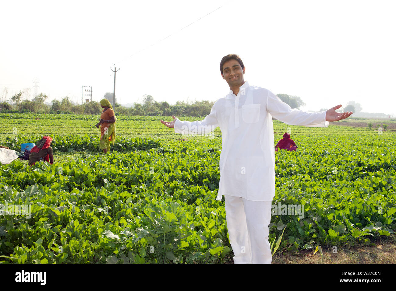 Portrait of a farmer showing his field Stock Photo - Alamy