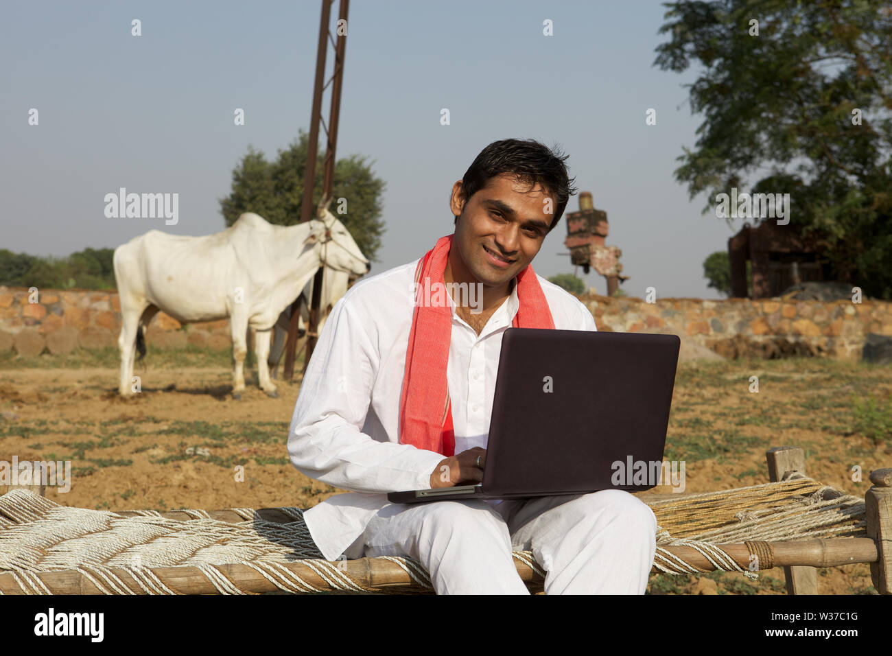 Farmer using a laptop Stock Photo - Alamy