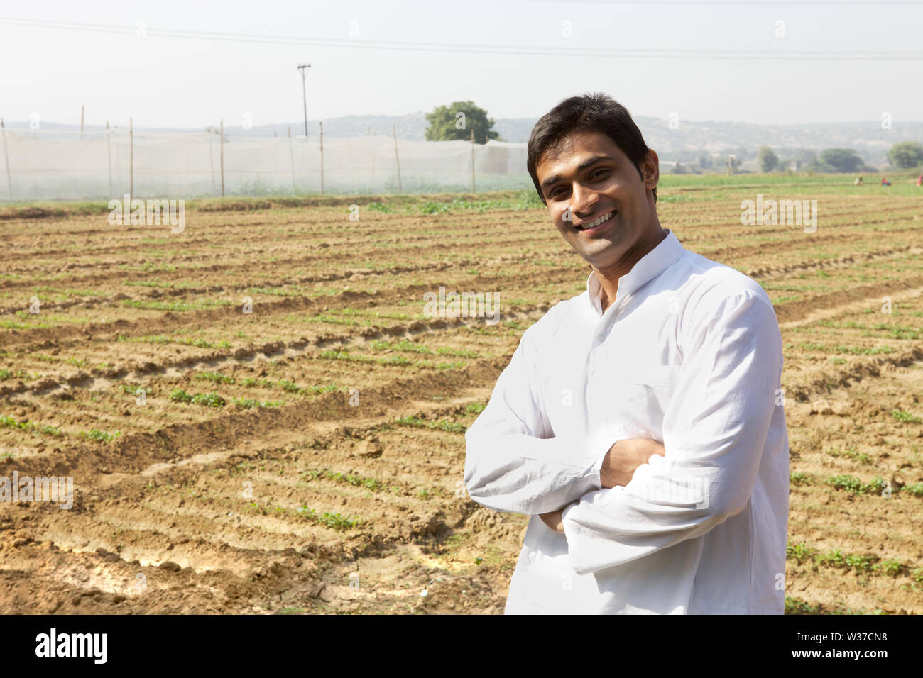 Portrait of a farmer smiling in a field Stock Photo - Alamy