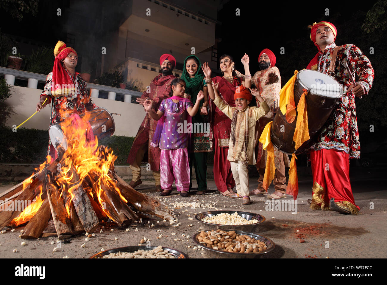 Family celebrating Lohri festival, Punjab, India Stock Photo