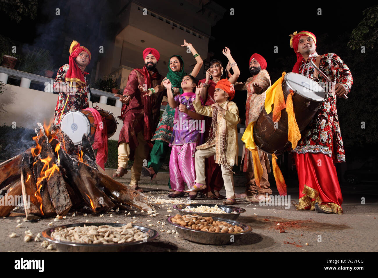 Family celebrating Lohri festival, Punjab, India Stock Photo