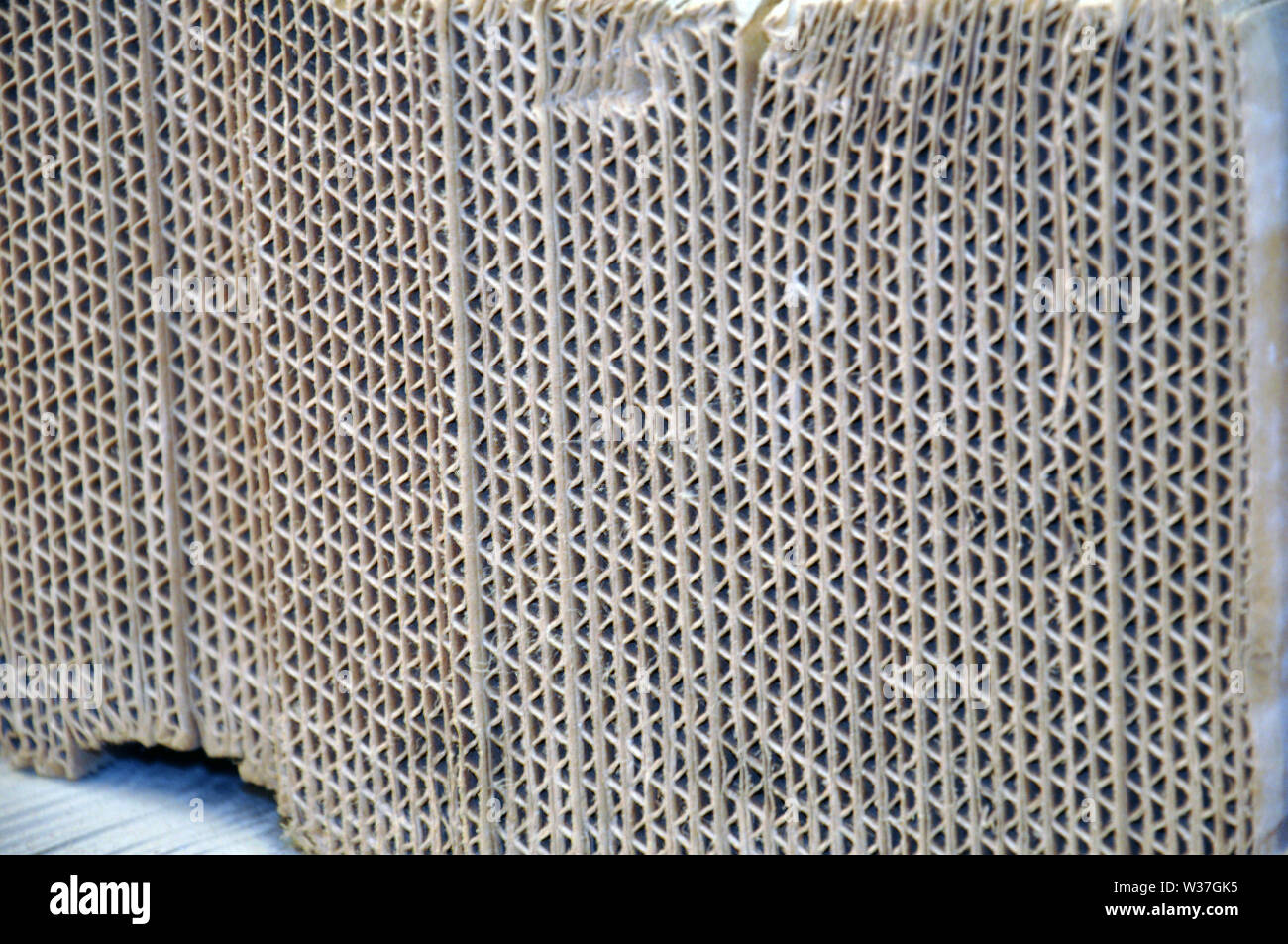 Corrugated cardboard sheets one by one, they are prepared for packing metal structures