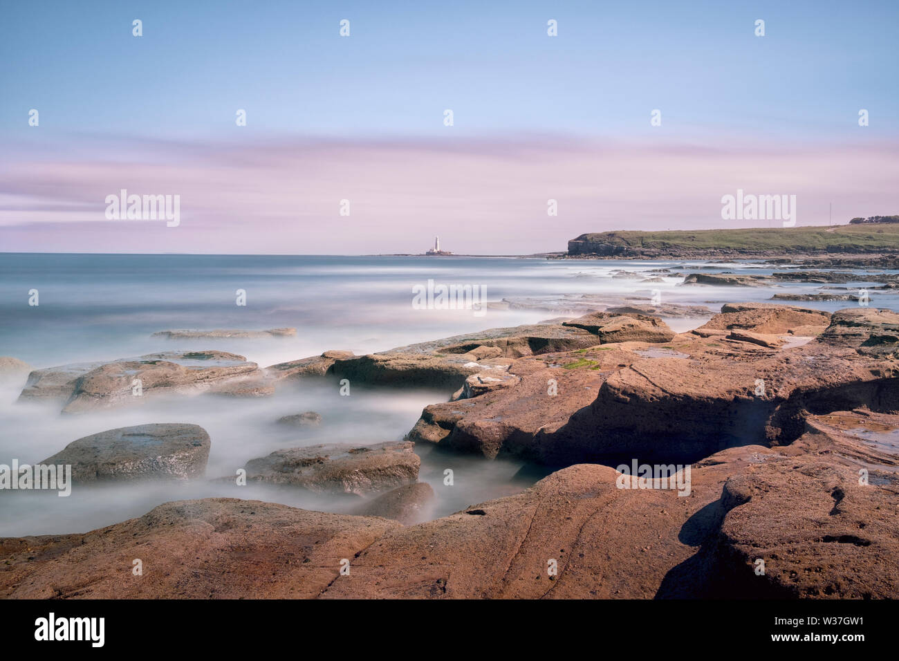 Rocks on the sea shore at Collywell Bay and St Mary's Island from Seaton Sluice on the Northumberland Coast Stock Photo