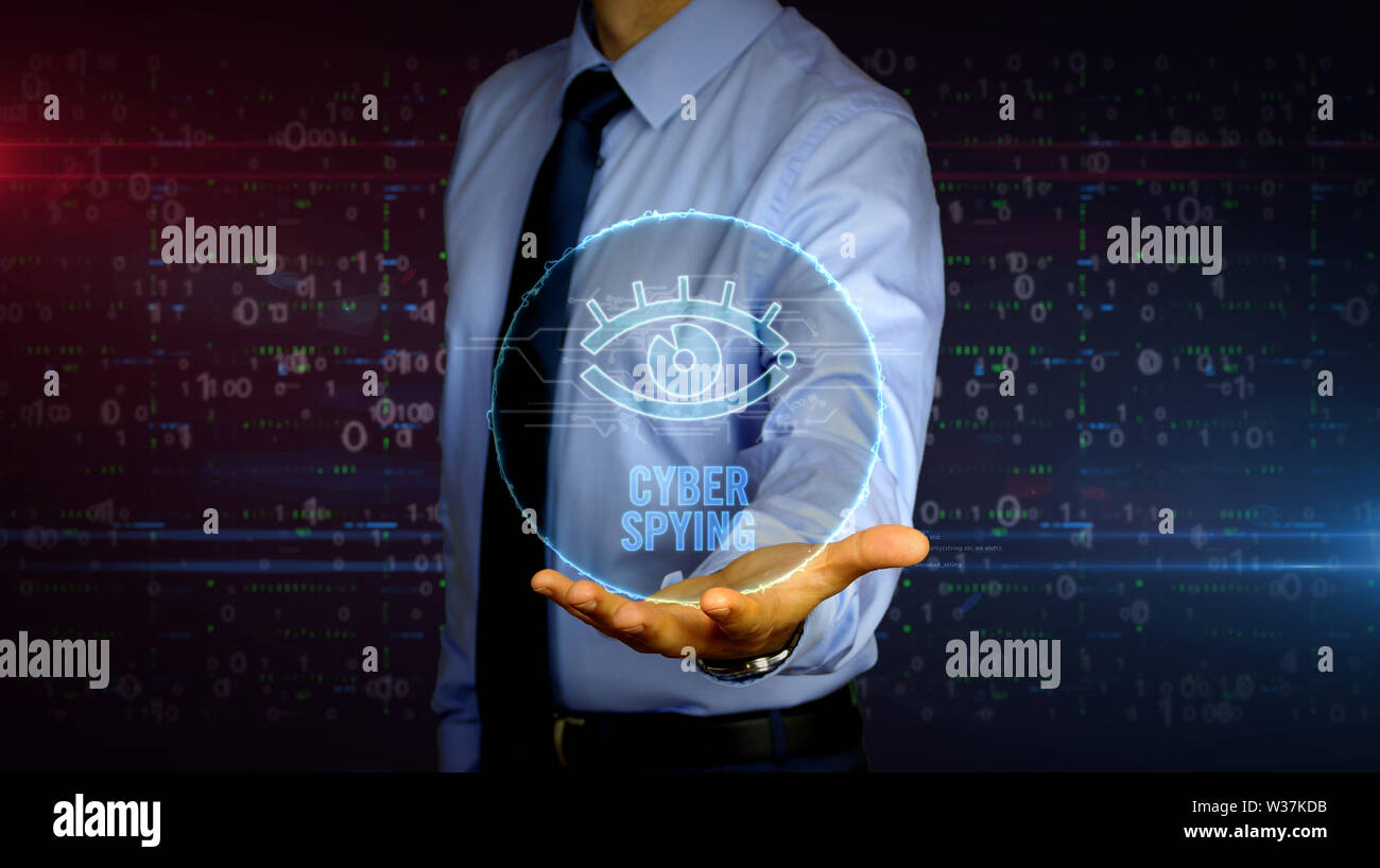 Man with dynamic cyber eye symbol hologram on hand. Businessman showing futuristic concept of digital surveillance, spying, hacking and violation of p Stock Photo