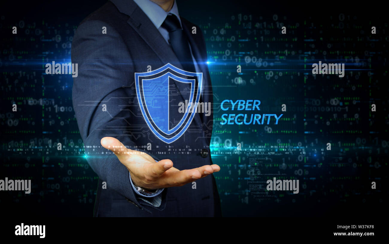 A businessman in a suit and screen with cyber security shield hologram ...