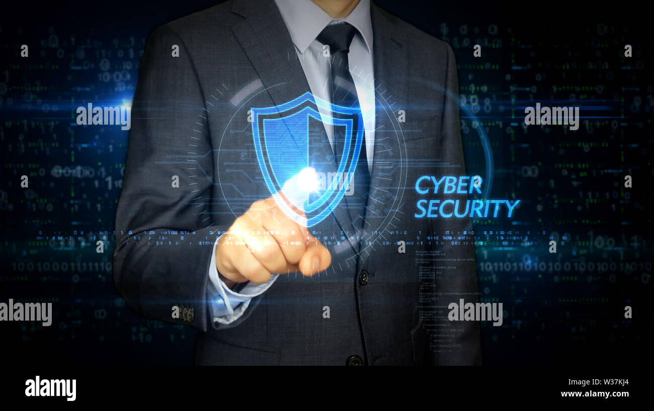 A businessman in a suit and screen with cyber security shield hologram ...