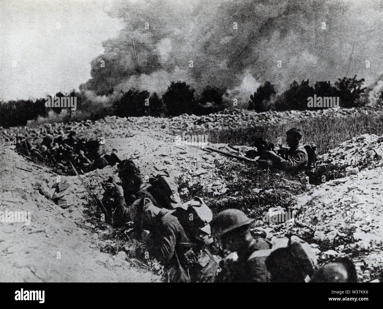 The caption on this photo that dates to the early 1920s reads: Americans in shell holes in No Man’s Land preparing for the gas waves coming toward them. Stock Photo