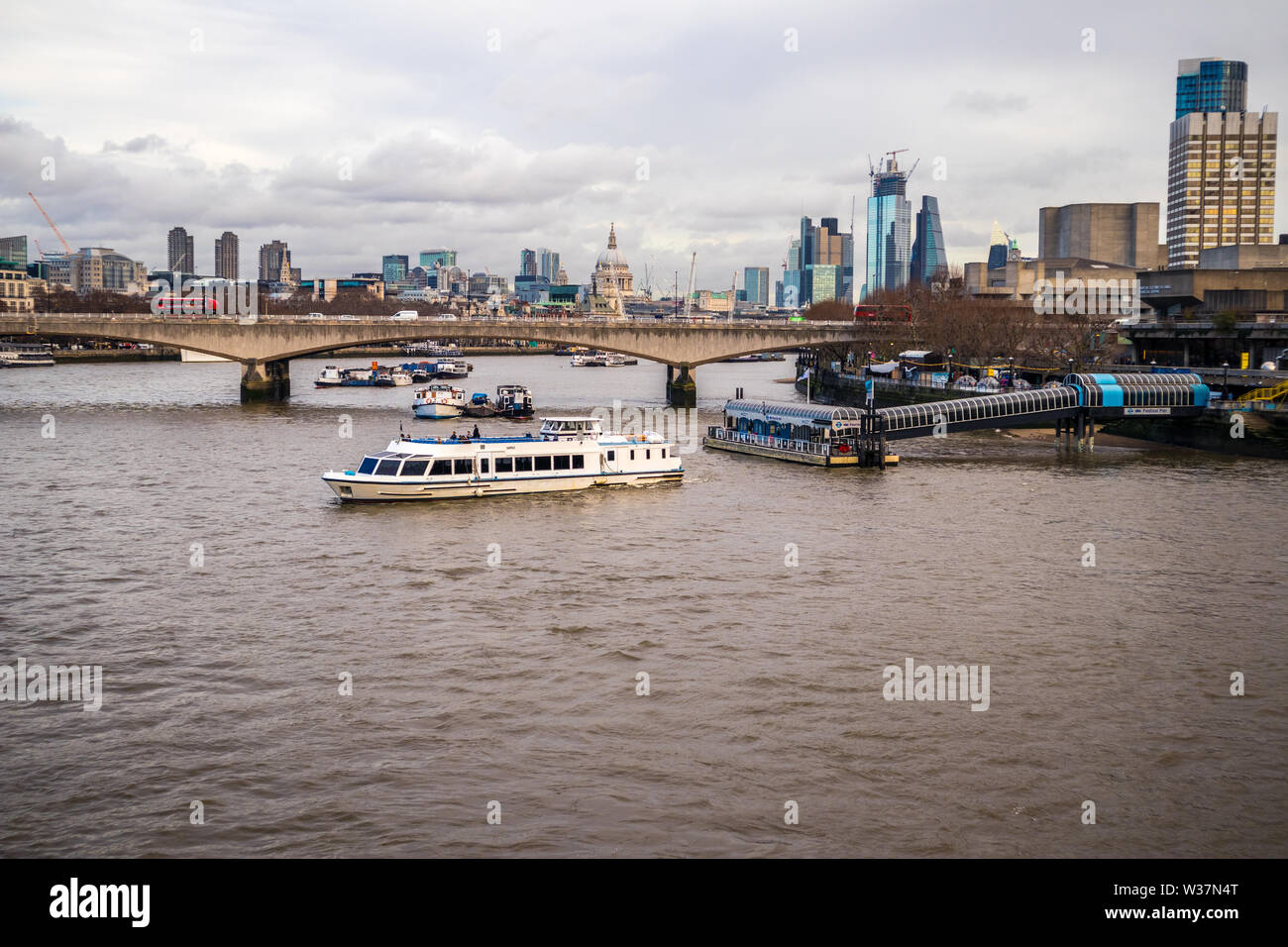 View of Waterloo Bridge, Festival pier, City of London and the River Thames, London UK from the Queen's Golden Jubilee Hungerford Footbridge Stock Photo